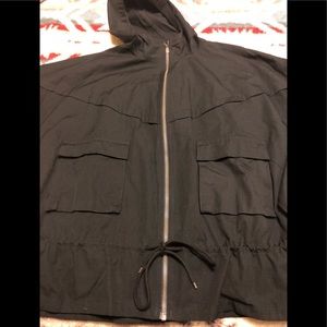 Nike woman’s Jacket. Zipper front. Two pockets with buttons and flap. 27 1/2 L